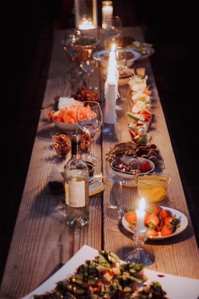 A long wooden table with plates of food on it